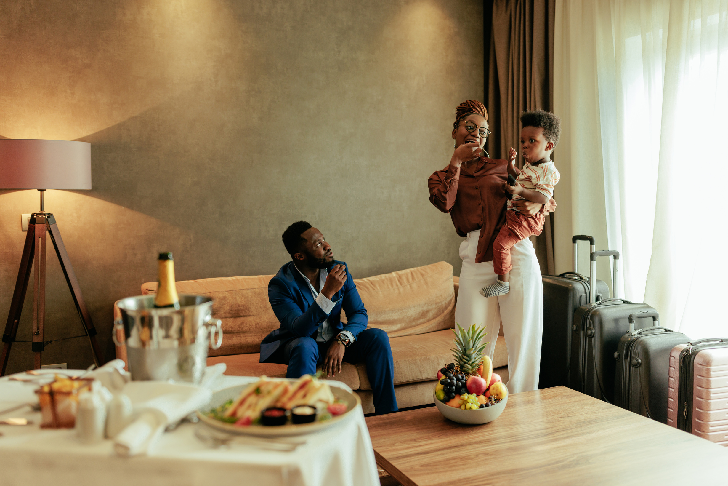 Wealthy family in fancy hotel room.